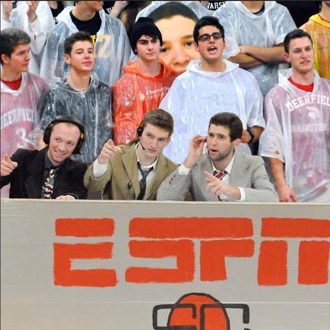 ARE YOU “RED”Y FOR THIS?- Members of the “Grateful Red,” Seniors Zach Shaltiel (left), Brendan Walsh (center) and Josh Mendelson (right) recreate an ESPN telecast while cheering on the Warriors at their second home game against Highland Park. Behind them, the crowd is in rain ponchos to participate in the Splash Zone, one of the many dress ups this season that have been implemented to increase school spirit.