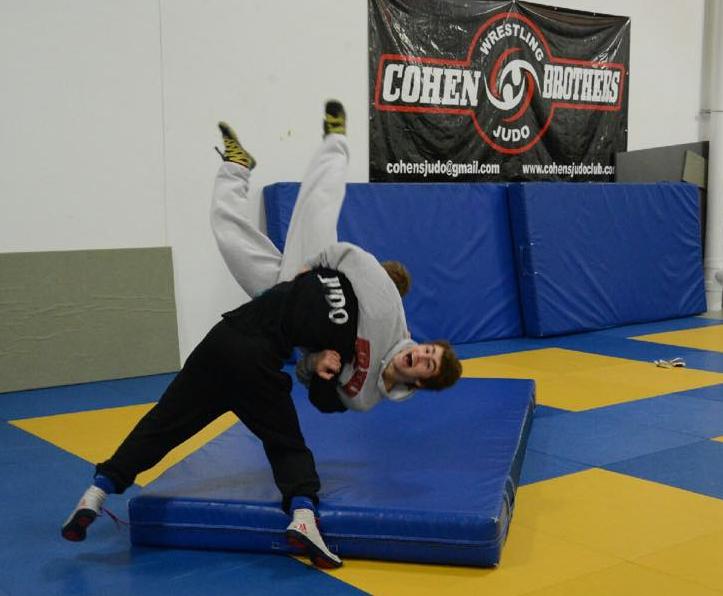 I believe i can fly: Juniors Andrew Mehrholz and Nick Kupets are practicing their judo and wrestling skills guided by Coach Aaron Cohen. Judo is a form of martial arts where the objective is to throw or take down opponents, these skills help develop the teams strength and coordination.