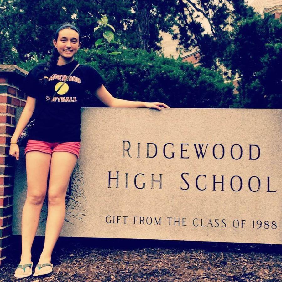 Julia Record, current DHS student, stands in front of her old school in New Jersey.