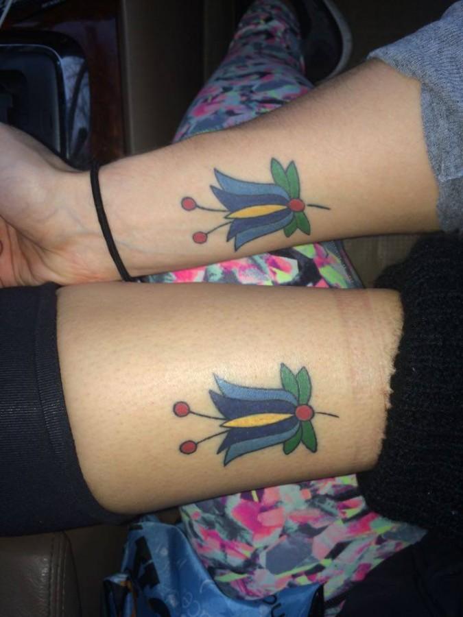 Junior Maggie Dudek and mother showcasing their matching tattoos 
