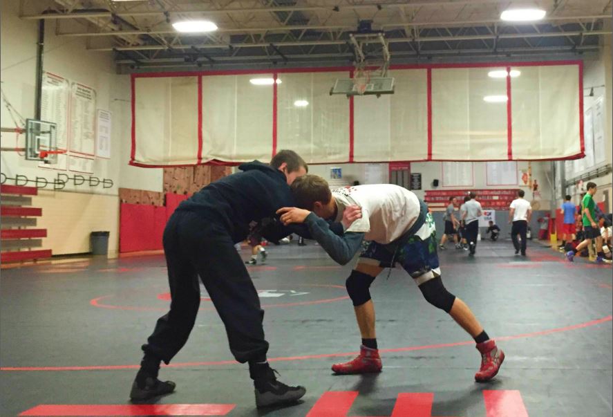 Varsity wrestlers practice their moves to prepare for upcoming competitions 