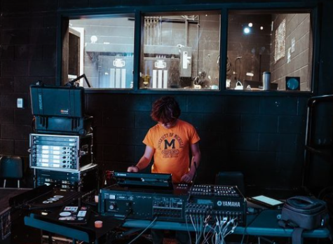 Zach Stutland working on a sound board. Image courtesy of Jeff Landsman.